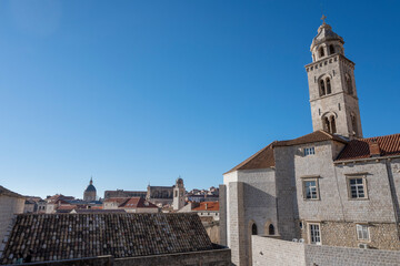 Fototapeta na wymiar Amazing Dubrovnik city walk on defence walls, above city rooftops and wonderful stone houses and landmarks