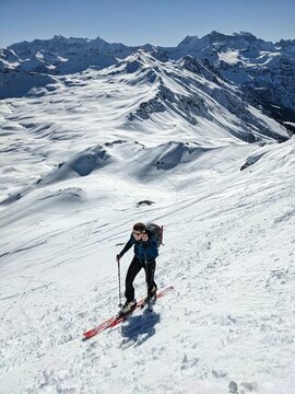 A young man on ski tou. rSki mountaineering in an unbelievably beautiful mountain world. Swiss Alps. Ski touring in winter. Spitzmeilen Glarus. High quality photo