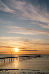 Fototapeta na wymiar sunset over the sea and pier