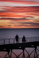 Fototapeta na wymiar silhouette of couple on the pier