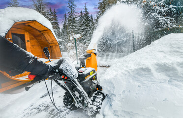 Clearing snow with a snowblower after snow fall.
