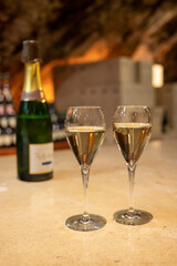 Tasting of rose champagne sparkling wine produced by traditional method in underground caves in Champagne, France
