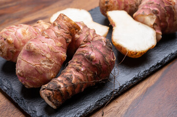 Group of fresh uncooked topinambur or Jerusalem artichoke roots
