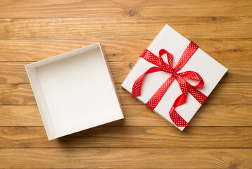 Open gift box on wooden background, top view