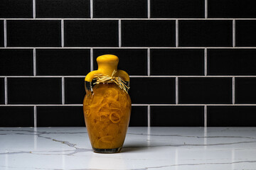 Yellow Topped Bottle of Orange Peppers and Oil 1