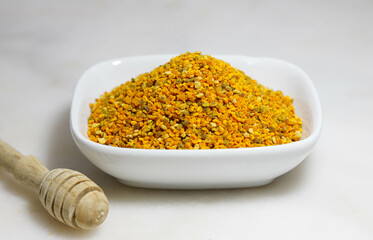 Raw brown, yellow, orange and blue flower pollen grains or bee bread.Bee pollen granules  Healthy...