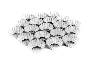 Tiny pie tins arranged in a geometric cluster isolated over white