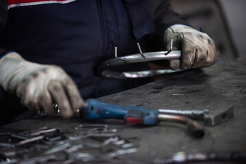 A worker in an industry preparing iron structures for welding
