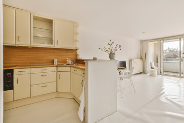 a kitchen and dining area in a house with sliding glass doors leading out onto the balcony to an...
