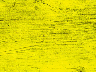 Yellow, colorful, abstract grainy texture of an old cracked wall. Light, saffron background. Amber 4k wallpaper with toned texture. Place for text for designer. Lemon wide panoramic banner