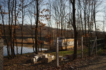 Yellow camper in the forest on the lake, spring time.