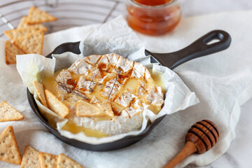 Camembert soft french cheese cooked in the oven with honey and thyme