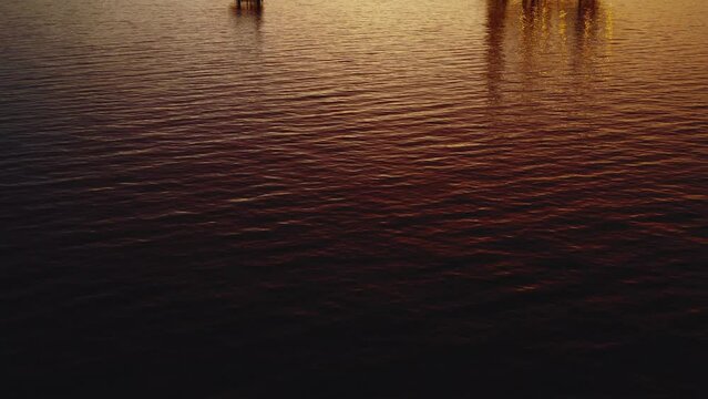 Jack up drilling rig and production platform in the middle of the ocean at sunrise time
