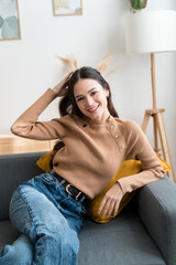 Smiling woman sitting on sofa