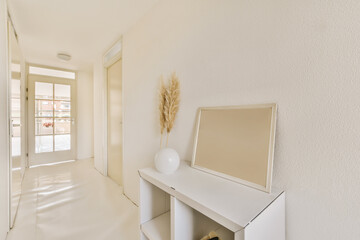 a white room with a mirror on the wall and an open door to another room in the photo is taken