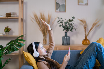 Young woman in headphones using smartphone