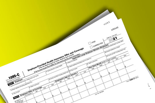 Form 1095-C documentation published IRS USA 10.27.2021. American tax document on colored