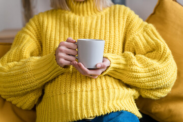 Crop woman with mug of hot drink