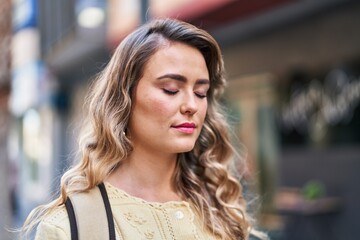 Young woman tourist breathing at street