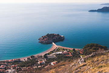 View of Sveti Stefan, a town in Budva Municipality, Budva Riviera, on the Adriatic sea coast, Saint Stephen island, Montenegro, sunny day with a blue sky, travel to Montenegro