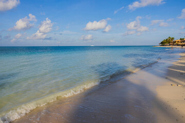 Beautiful view of sunrise on sandy beach hotel in Atlantic ocean. Aruba.