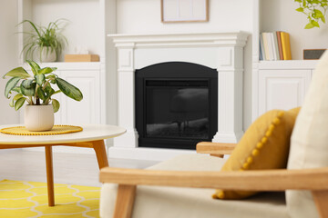 Spring atmosphere. Cosy furniture and potted plants near fireplace in stylish room