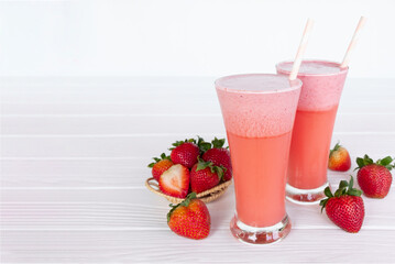 Strawberry yogurt fruit juice smoothie pink colorful fruit juice milkshake blend beverage healthy high protein the taste yummy In glass drink episode morning on white wood background.
