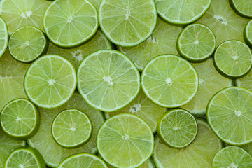 Fototapeta na wymiar Fresh lime slices as background, top view