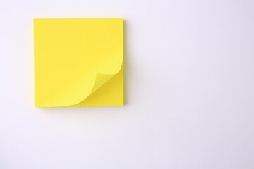Blank paper note on white background, top view. Space for text