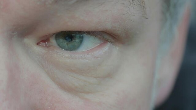 A macro shot of a man in his fifties and his left eye