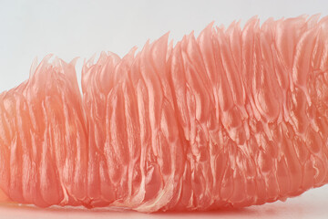 close-up macro view of ripe pomelo fruit, citrus maxima, teardrop or pear shaped large asian citrus fruit flesh or pulp isolated on white background