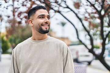 Young arab man smiling confident standing at park