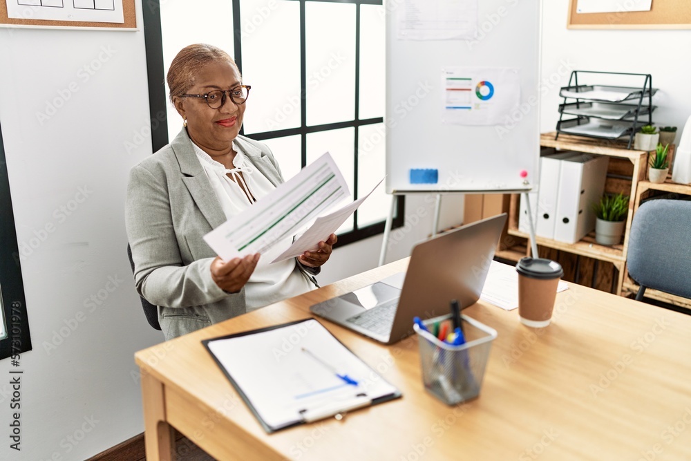 Sticker senior african american woman business worker reading paperwork working at office