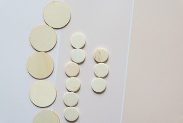 set of wood circle shapes on beige paper pad with paint chip element - macro lens, particular focus