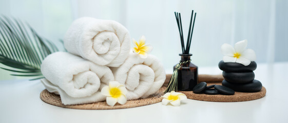 Spa accessory composition set in day spa hotel , beauty wellness center . Spa product are placed in luxury spa resort room , ready for massage therapy from professional service .