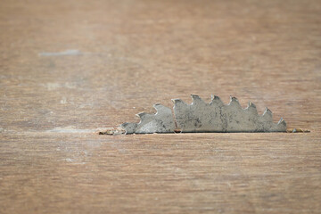 sharp metal saw on wood plank texture background, construction machine