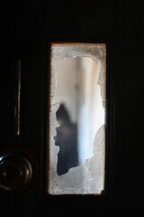 burn dirty black wood door with broken glass texture background