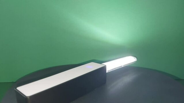 Led lamp with a power bank is spinning on a stand