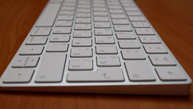 White wireless keyboard on the table close-up.