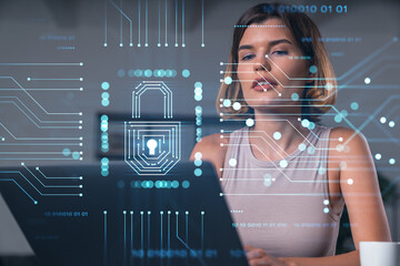 Thoughtful businesswoman in casual wear typing on laptop at office workplace with coffee cup. Concept of distant work, business education, internet surfing, information technology. Lock hologram