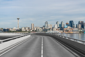 Empty urban asphalt road exterior with city buildings background. New modern highway concrete construction. Concept way to success. Transportation logistic industry fast delivery. Seattle. USA.