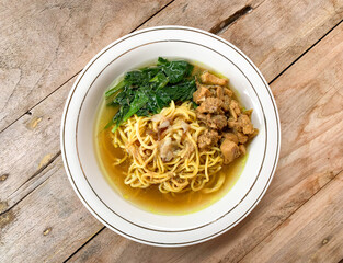 Noodle chicken soup (mie ayam) with vegetable, Indonesia food served on bowl.