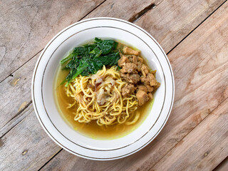 Noodle chicken soup (mie ayam) with vegetable, Indonesia food served on bowl.