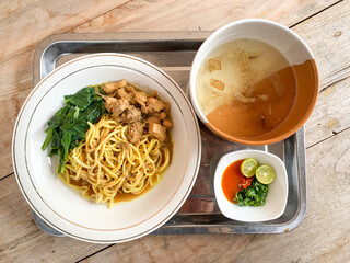 Noodle chicken with soup (mie ayam) Indonesia food served on bowl.