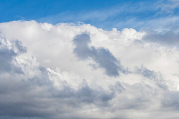 Soft white cloud cover in the blue sky