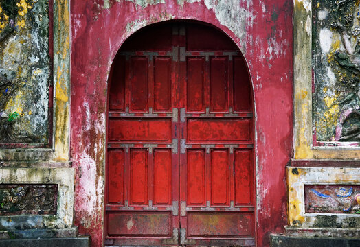Ancient wooden red door in Hue Emperor Citadel, Vietnam                              