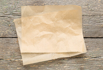Sheets of baking paper on wooden background