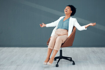 Chair, carefree and mockup with a business black woman sliding on the floor of her office feeling stress free. Freedom, relax and success with a crazy female employee riding a seat in the workplace