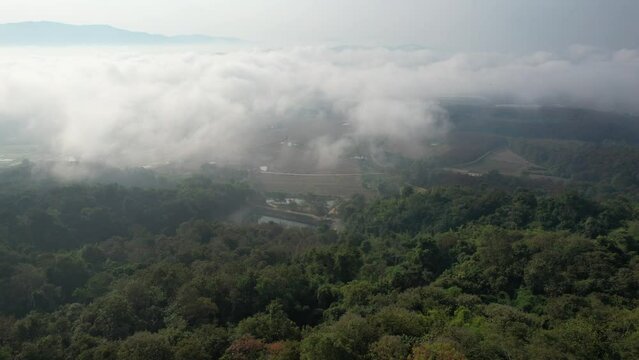Aerial view by drone of the temple and skywalk by the Mekong river on foggy day in Chiang rai, Thailand