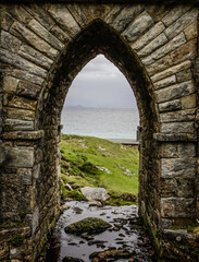 Fototapeta na wymiar An arch below a stone bridge at Keem beach, Achill Island, Ireland